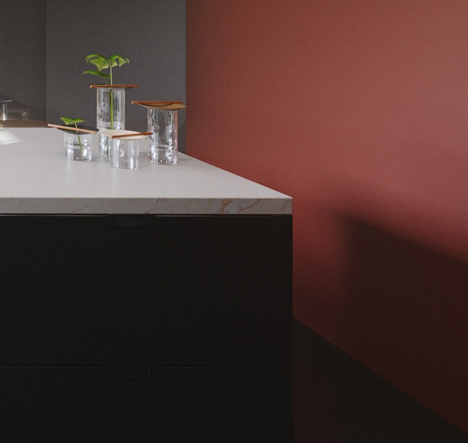 TTD detail of the marble island corner: four glass tumblers with wooden lids holding plant cuttings against an oxblood red wall.